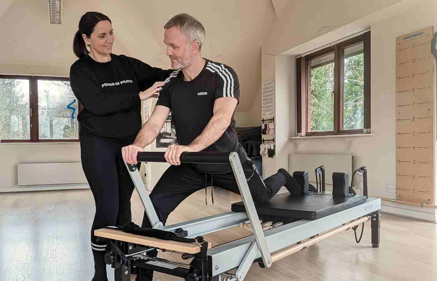Pilates instructor giving individual guidance to a client