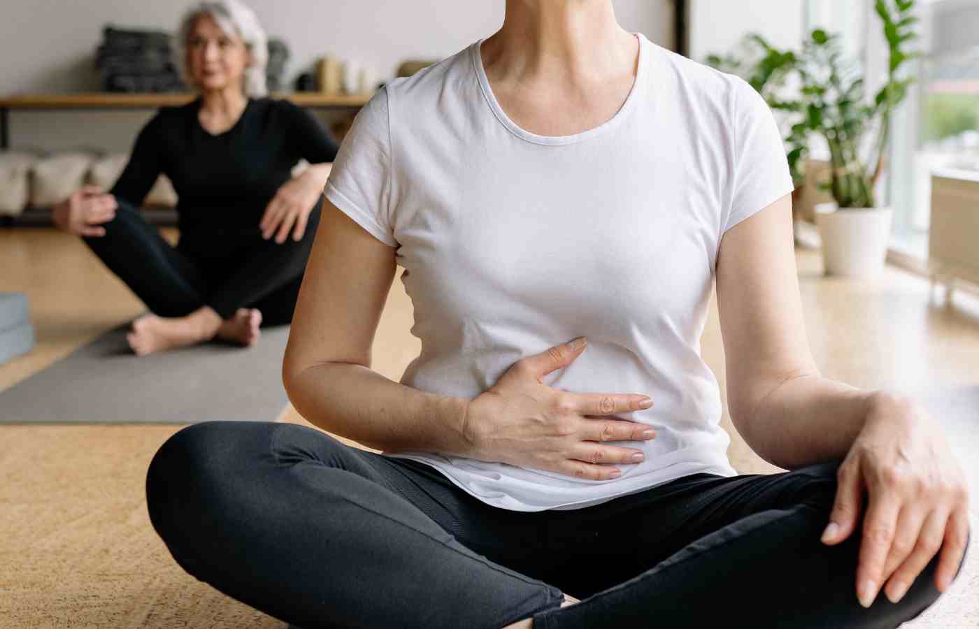 Pilates instructor giving individual support during a class